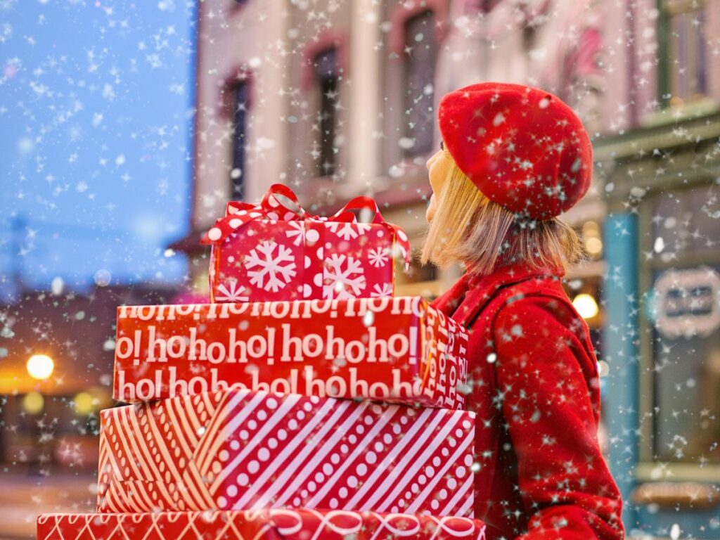 woman carrying gifts during snowfall