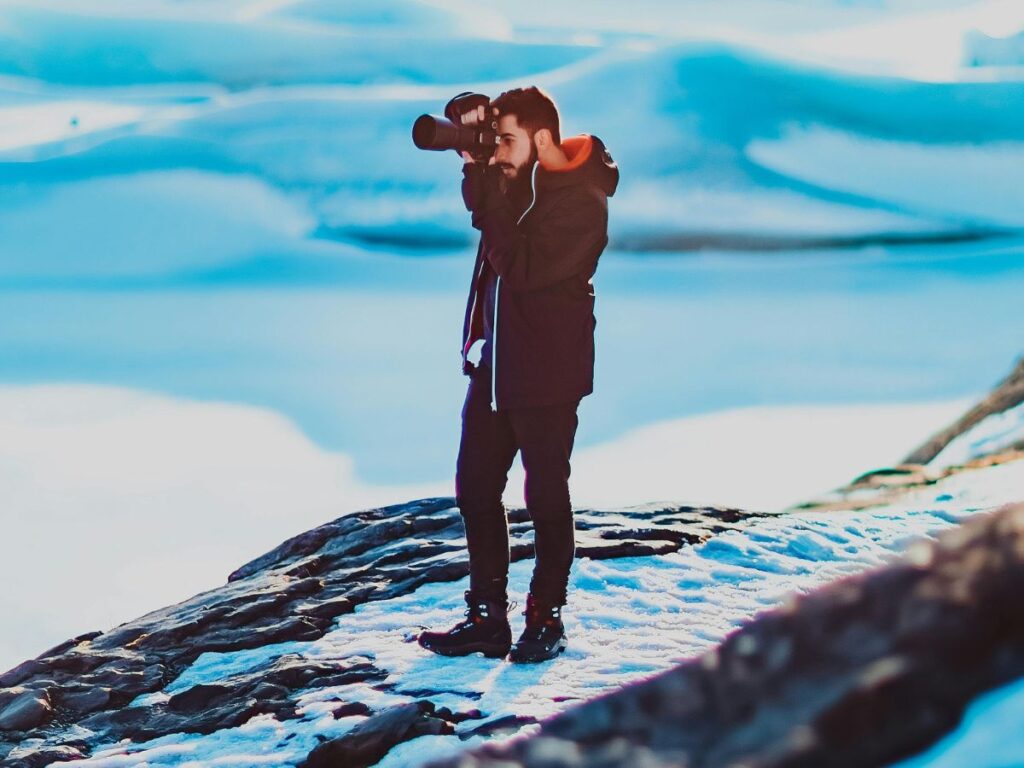 man photographing in winter