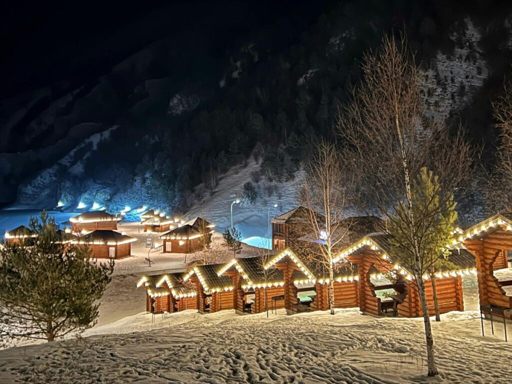 winter cabins lit at night