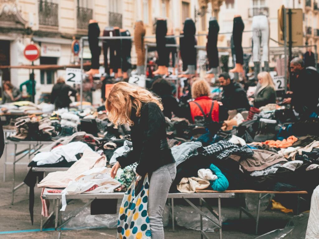woman going through clothes in a flea market