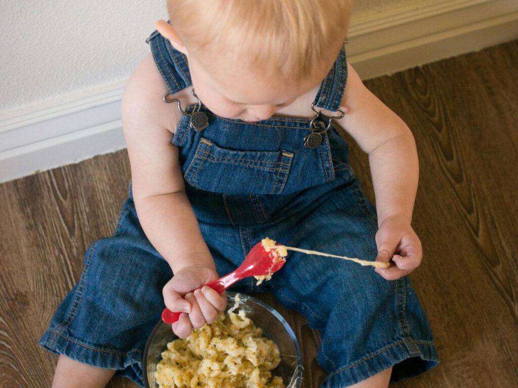 baby eating mac and cheese