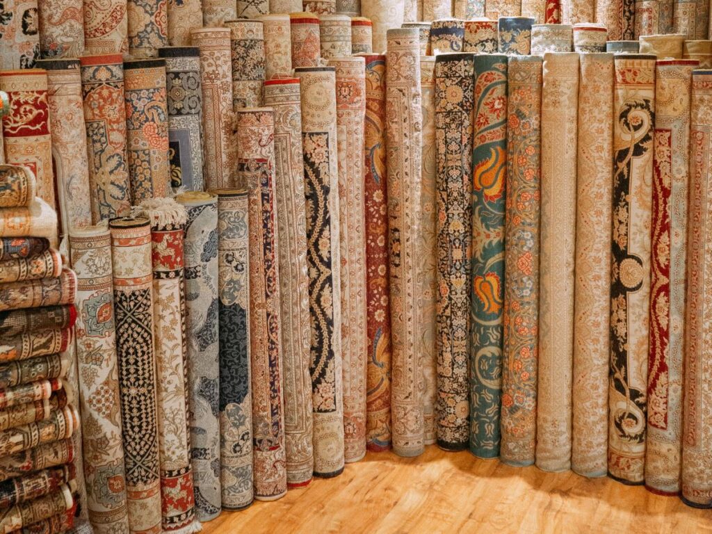rugs rolled up in a shop