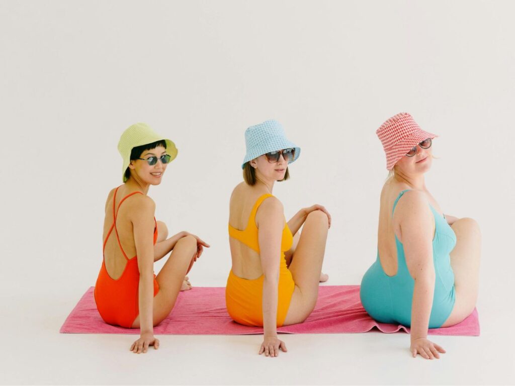 women wearing swimsuit on a swimming mat