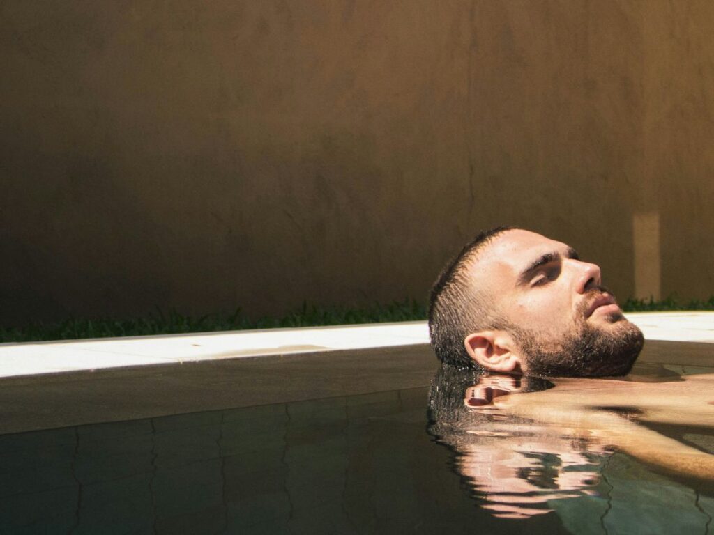 man relaxing in pool