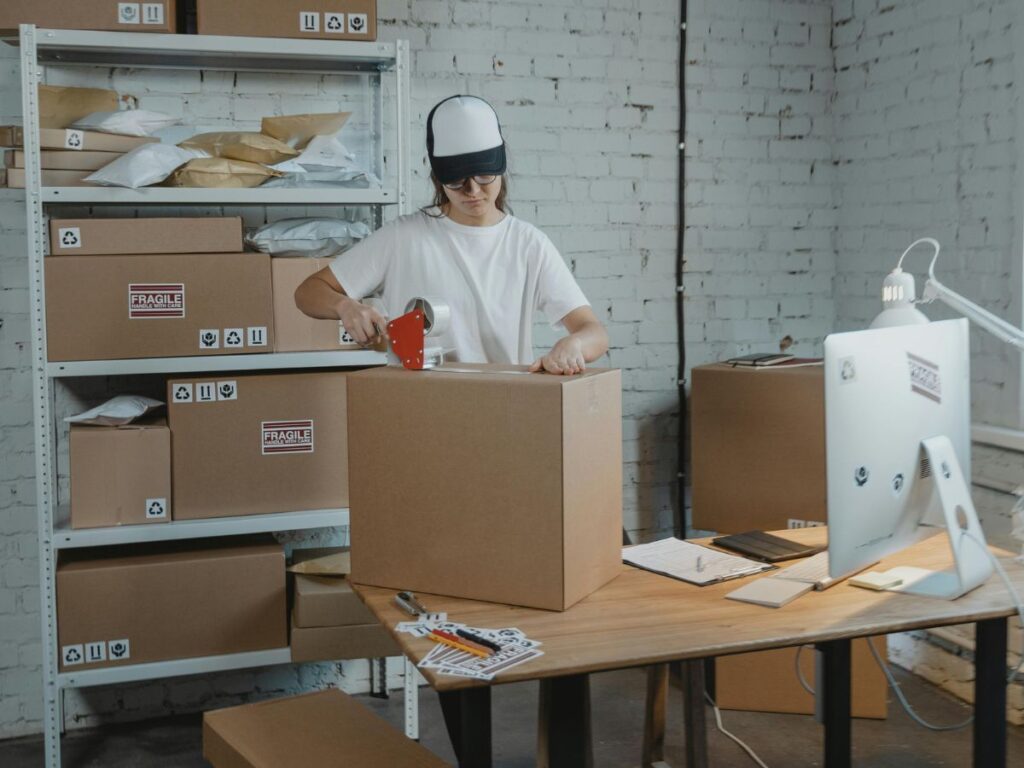 woman taping the boxes for transport