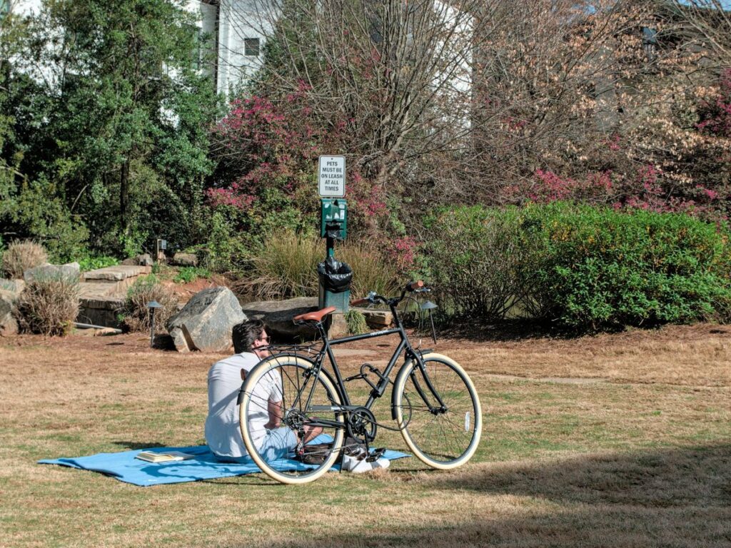 man sitting with his bike