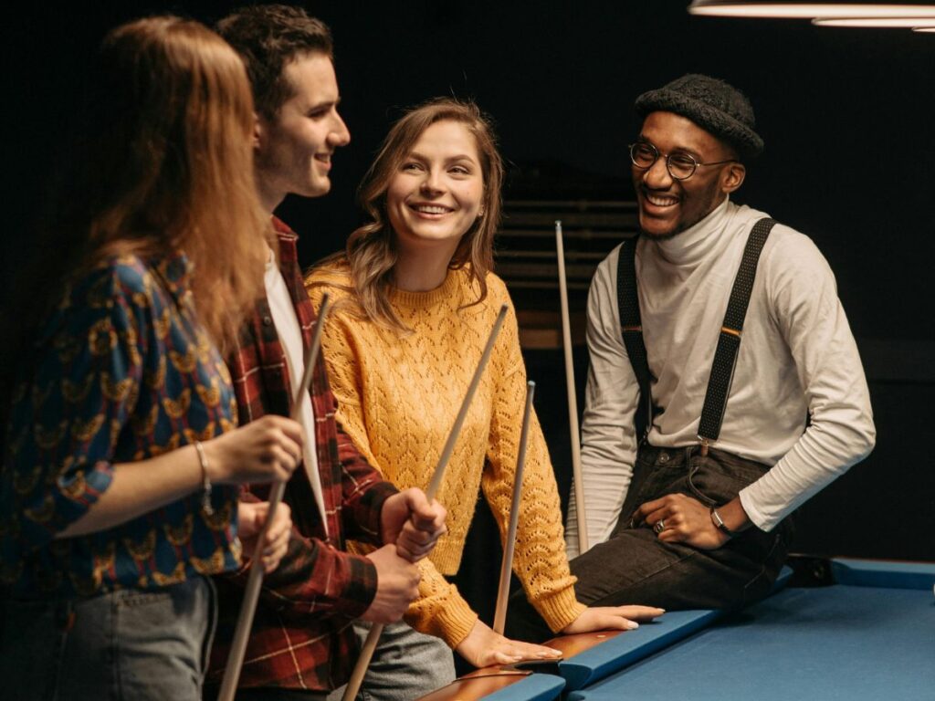 group of friends playing billiards