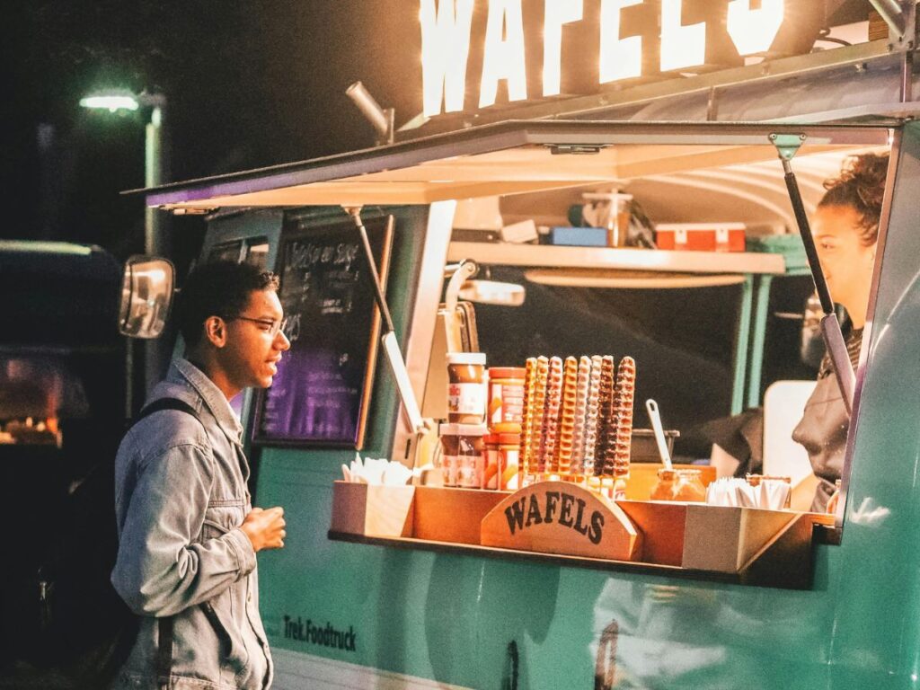 man buying from a waffle food truck