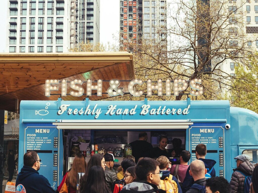 people buying from a fish and chips food truck