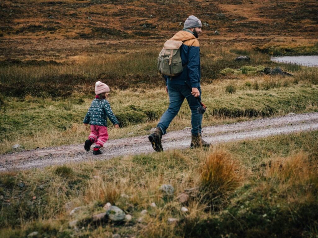 man hiking with his little daughter