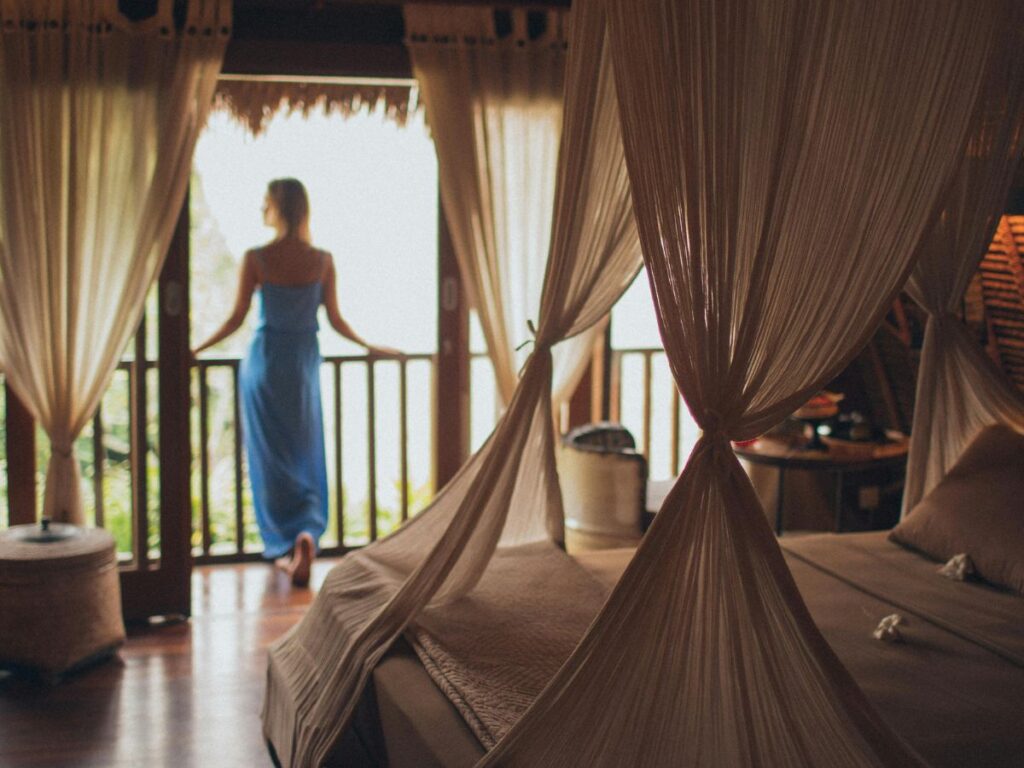 woman standing on balcony of room