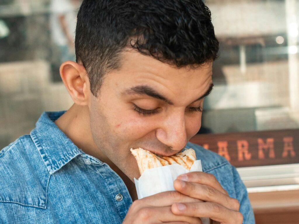 man eating shawarma