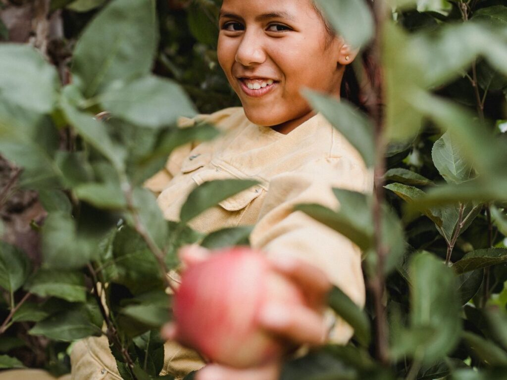 woman holding apple