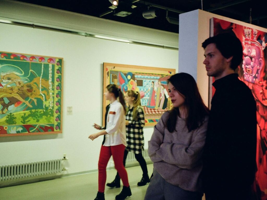 people watching art in a gallery