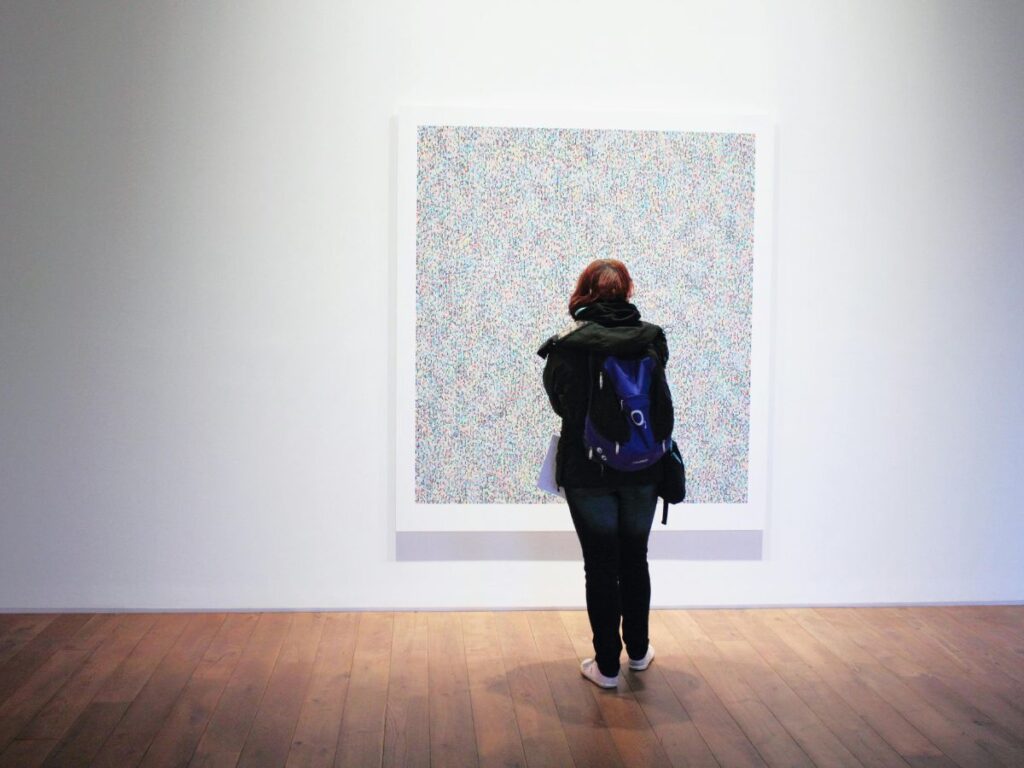 girl watching art in a gallery