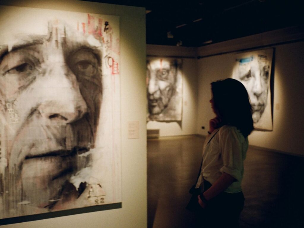 girl looking at painting in an art gallery