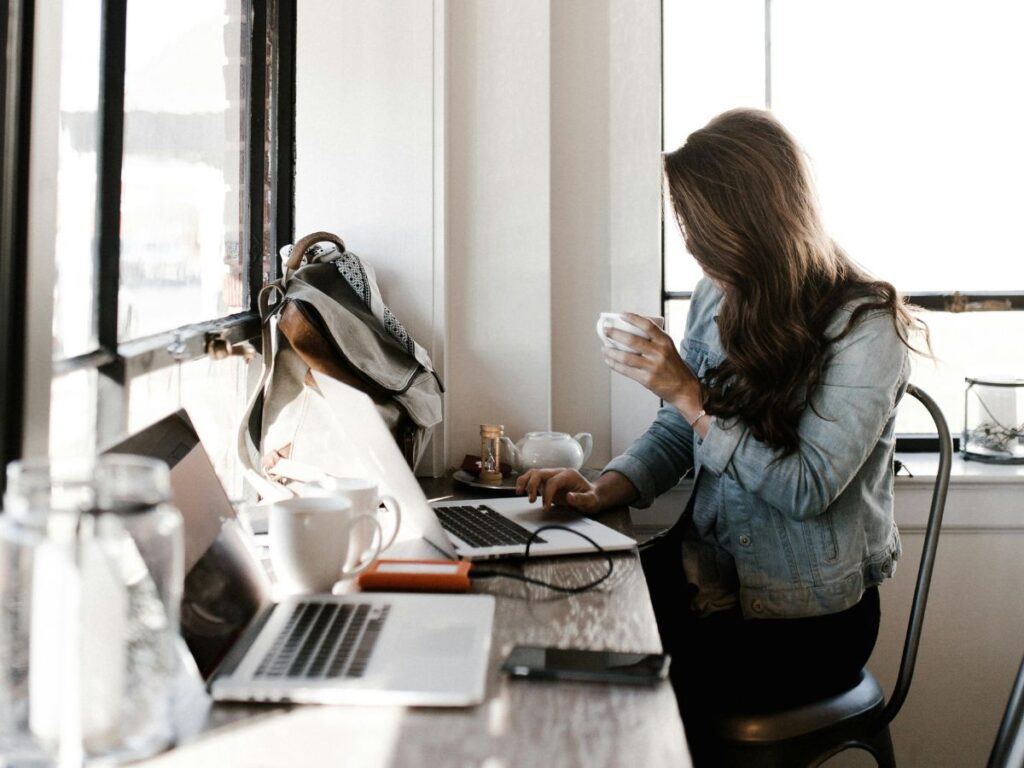woman drinking coffee and working