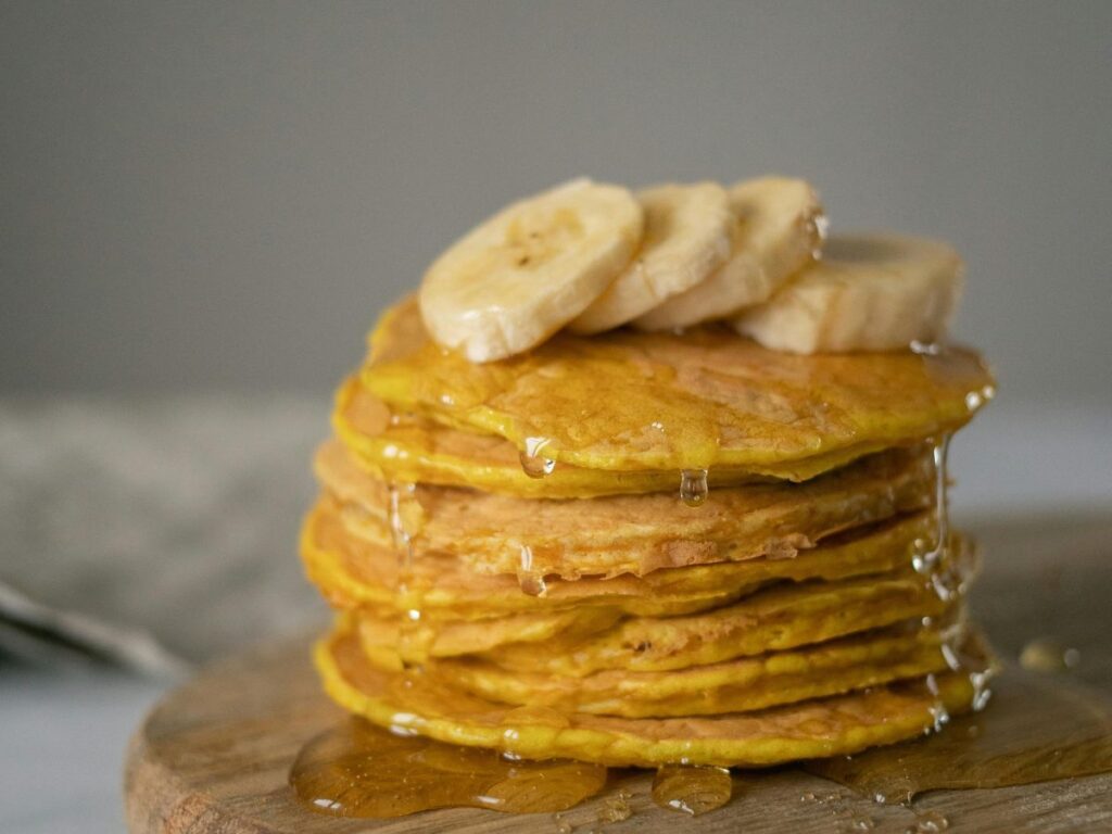 pancakes dripped in honey with banana toppings