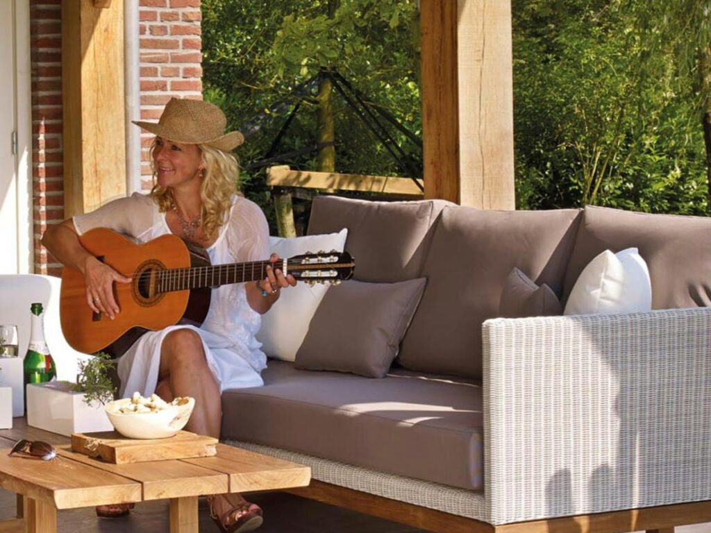 woman playing guitar in patio