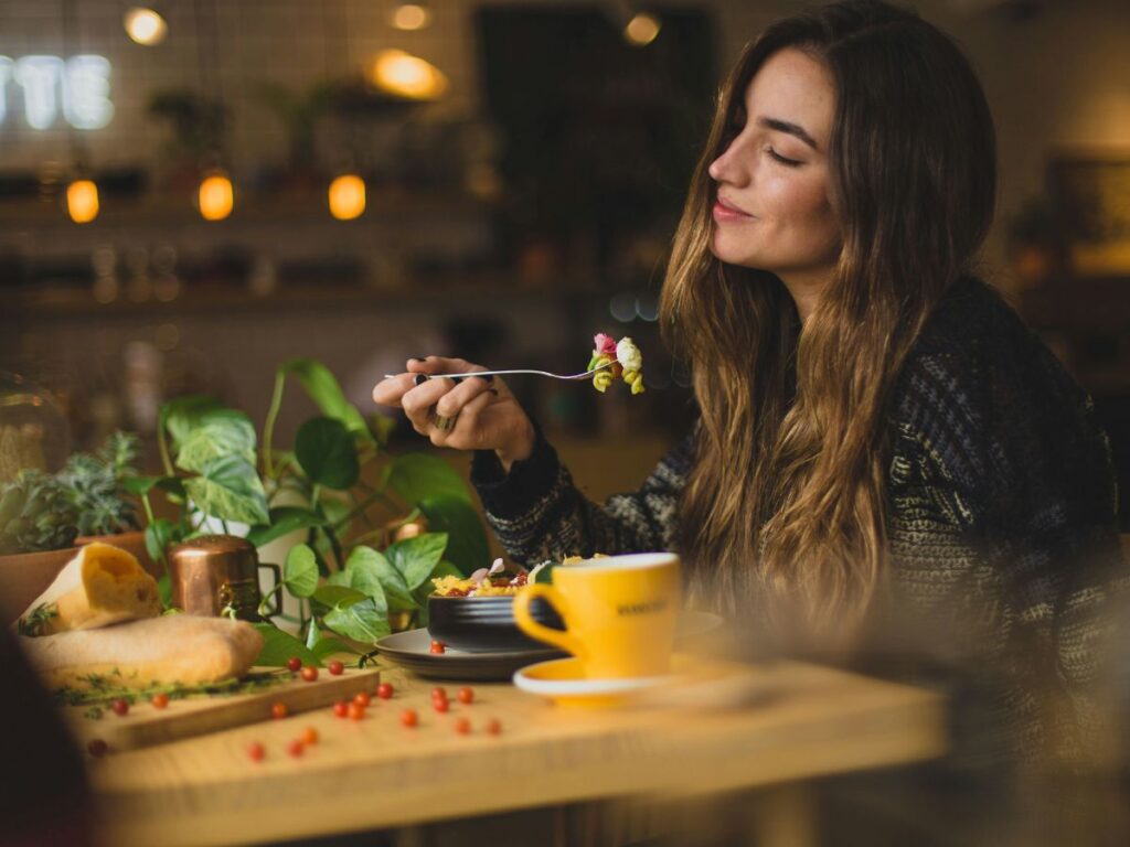 woman eating food in a restaurant