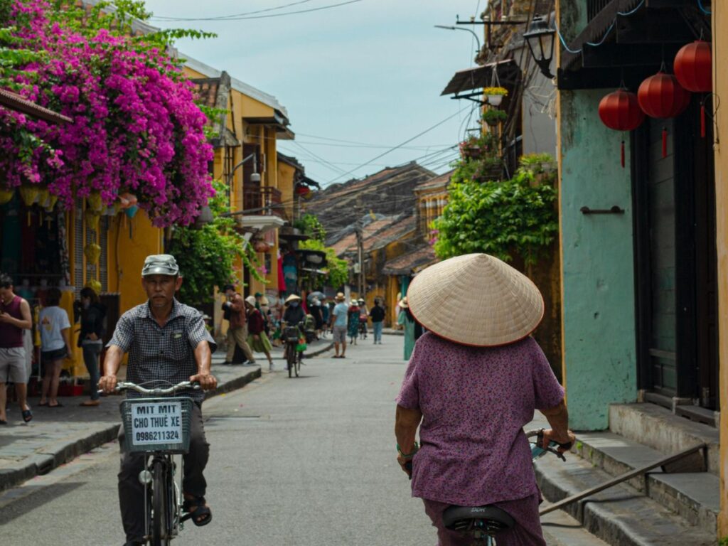 people cycling in a small town