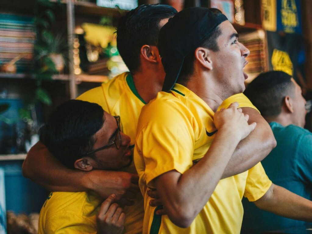 people cheering in a sports bar