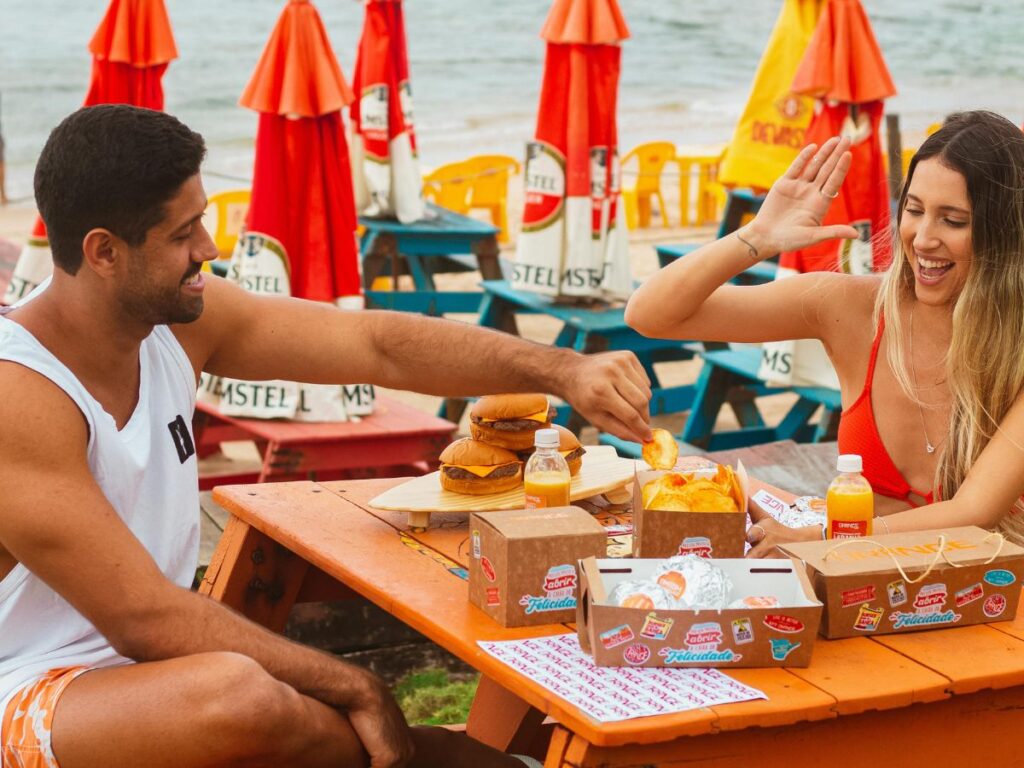 couple eating food on a beach