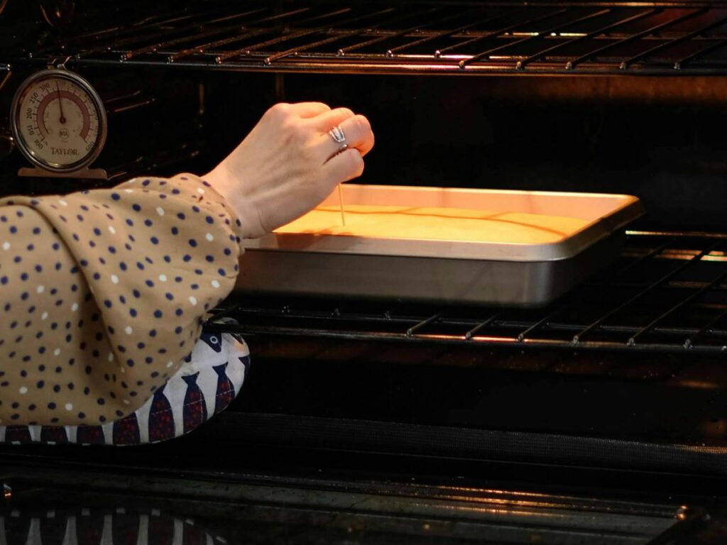 putting baking dish into oven