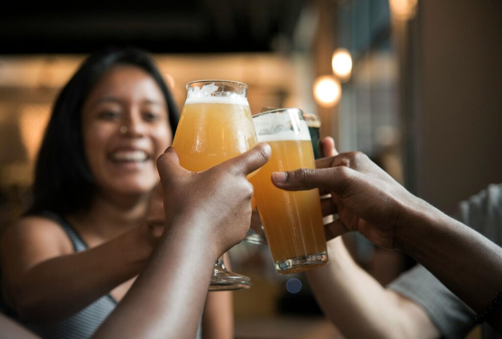 women cheering their drinks