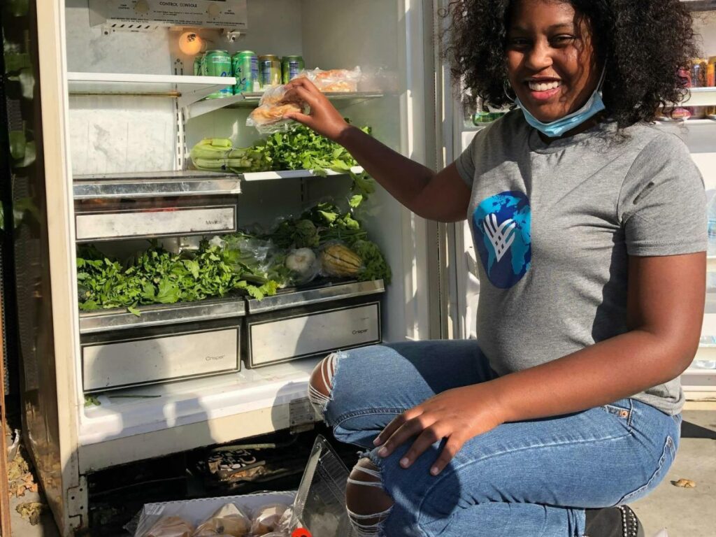 volunteer filling a fridge