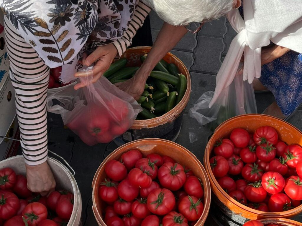 man and woman buying bell peppers