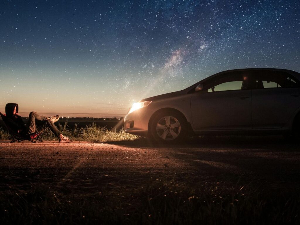 man in a peaceful place with his car