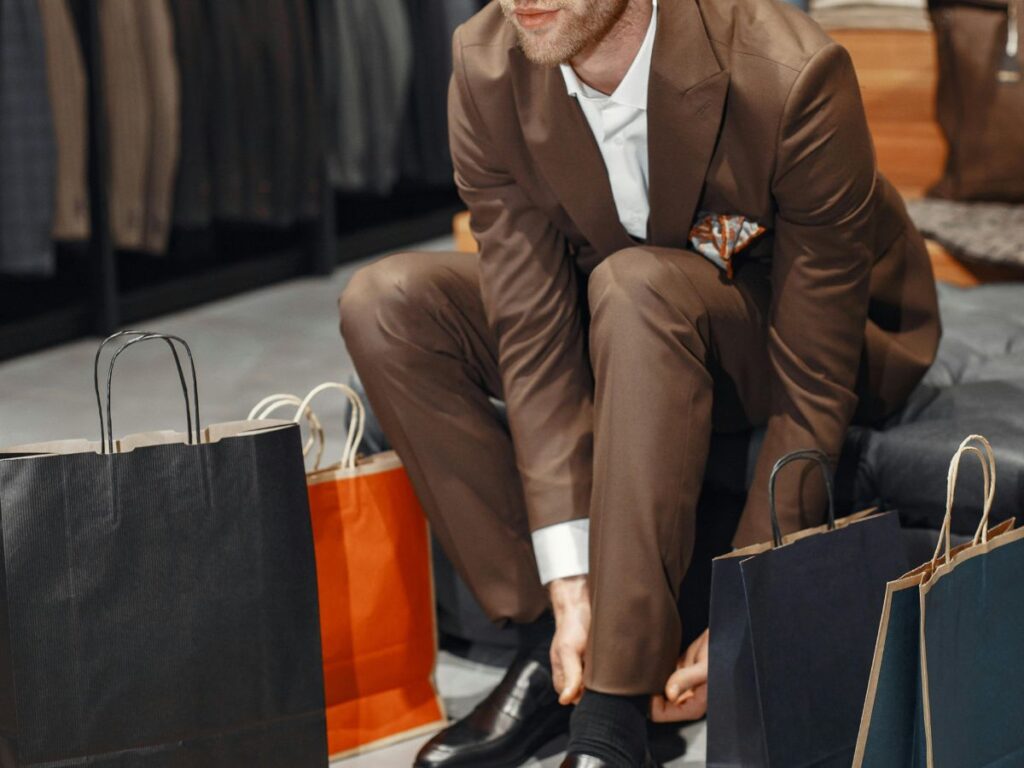 men wearing shoes and buying clothes