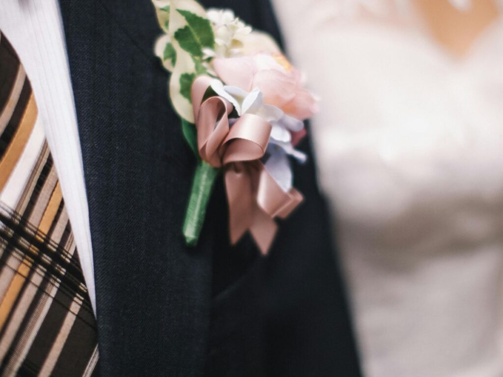 man wearing wedding suit and broch 