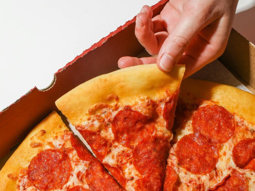 taking a pepperoni pizza slice