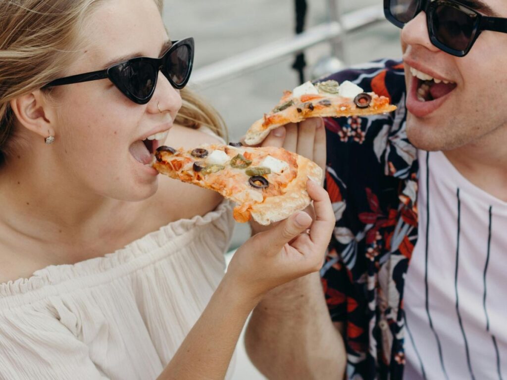 people eating pizza slices