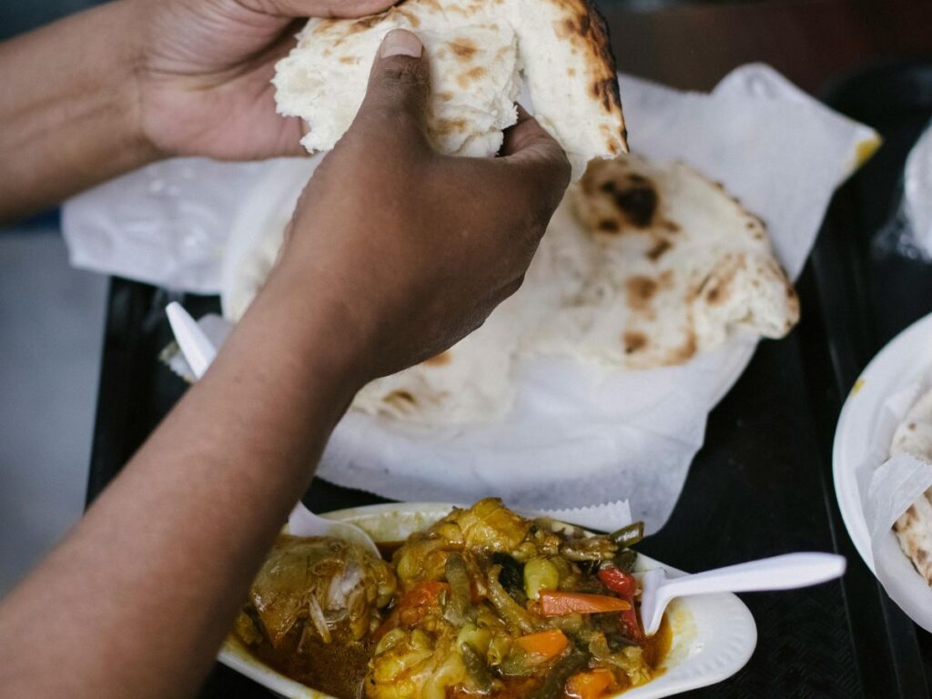 man eating roti