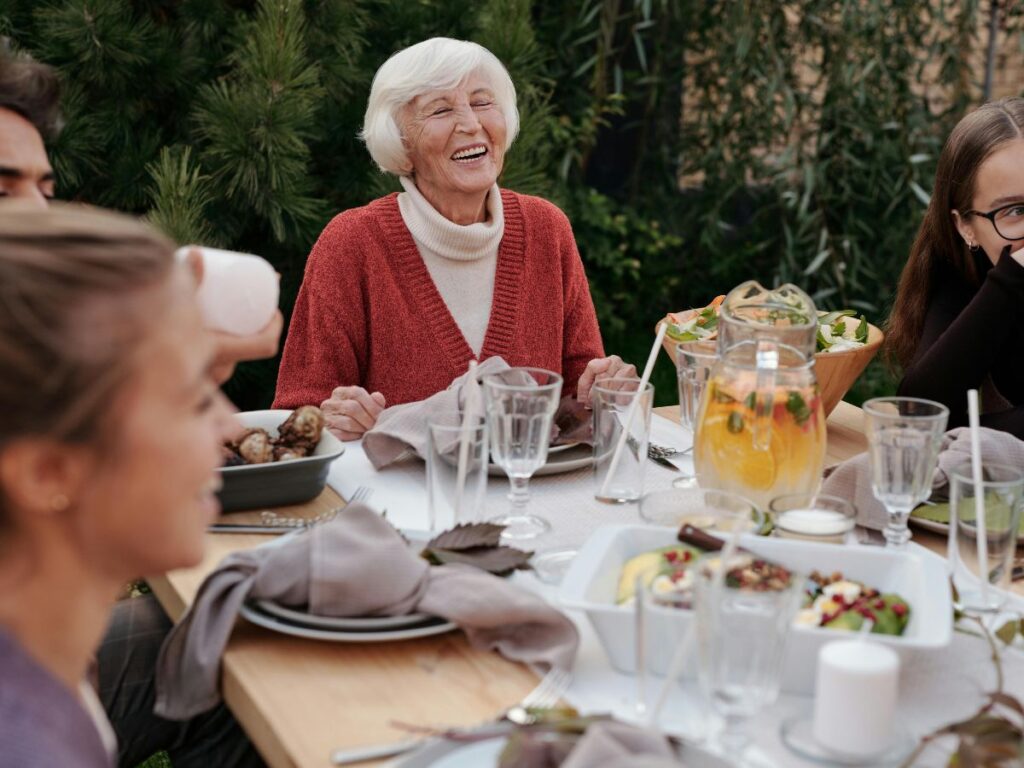 old woman sitting in open air restaurant