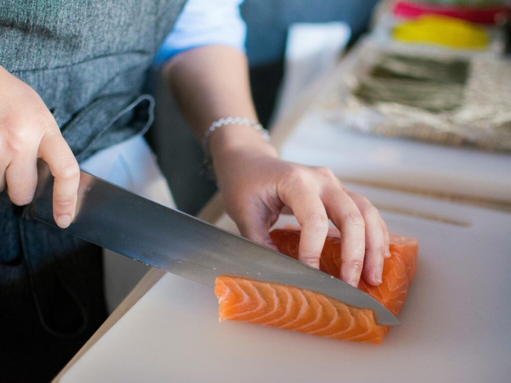 chef cutting fish for sushi