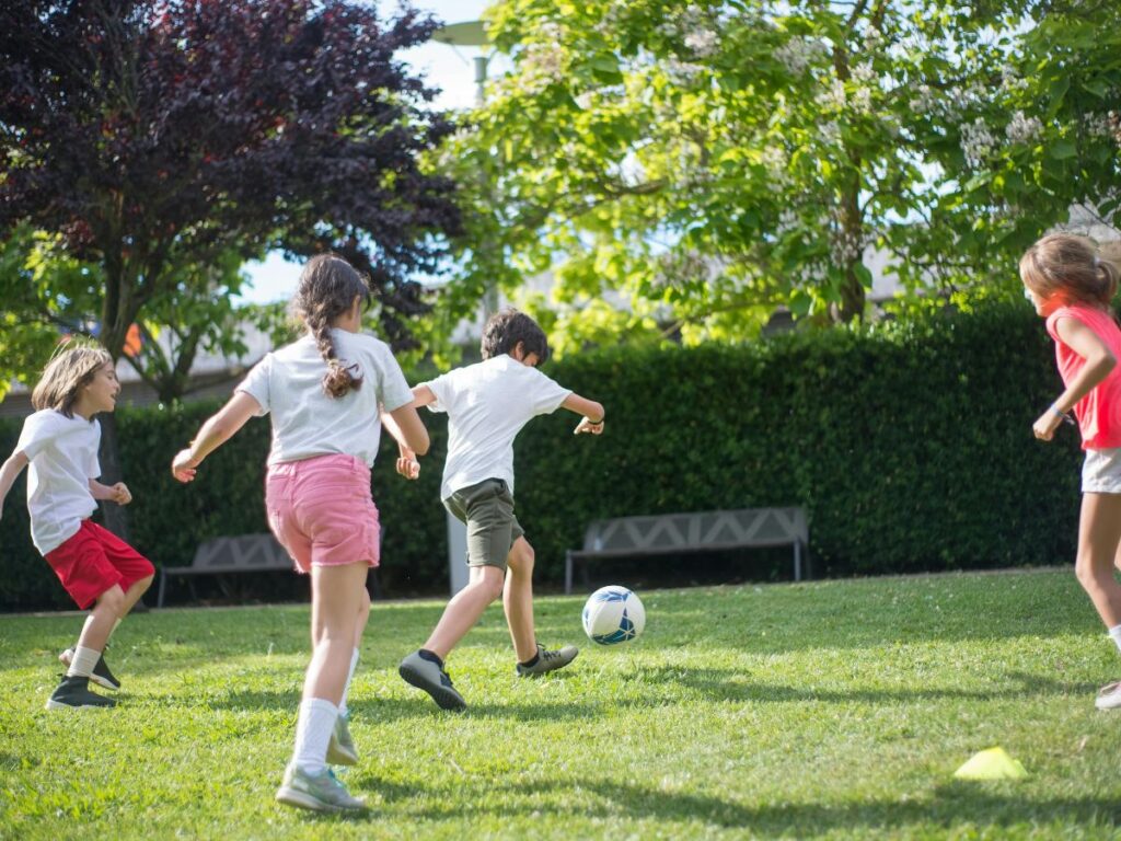 kids playing football in a park