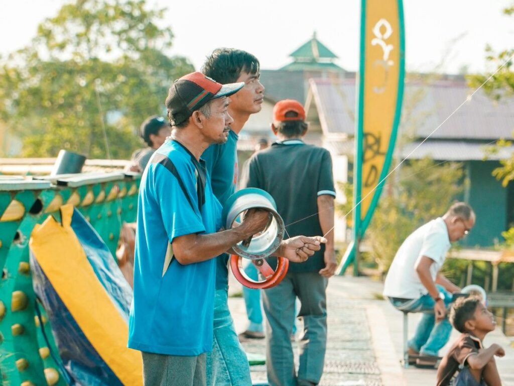 kid flying kite with his father