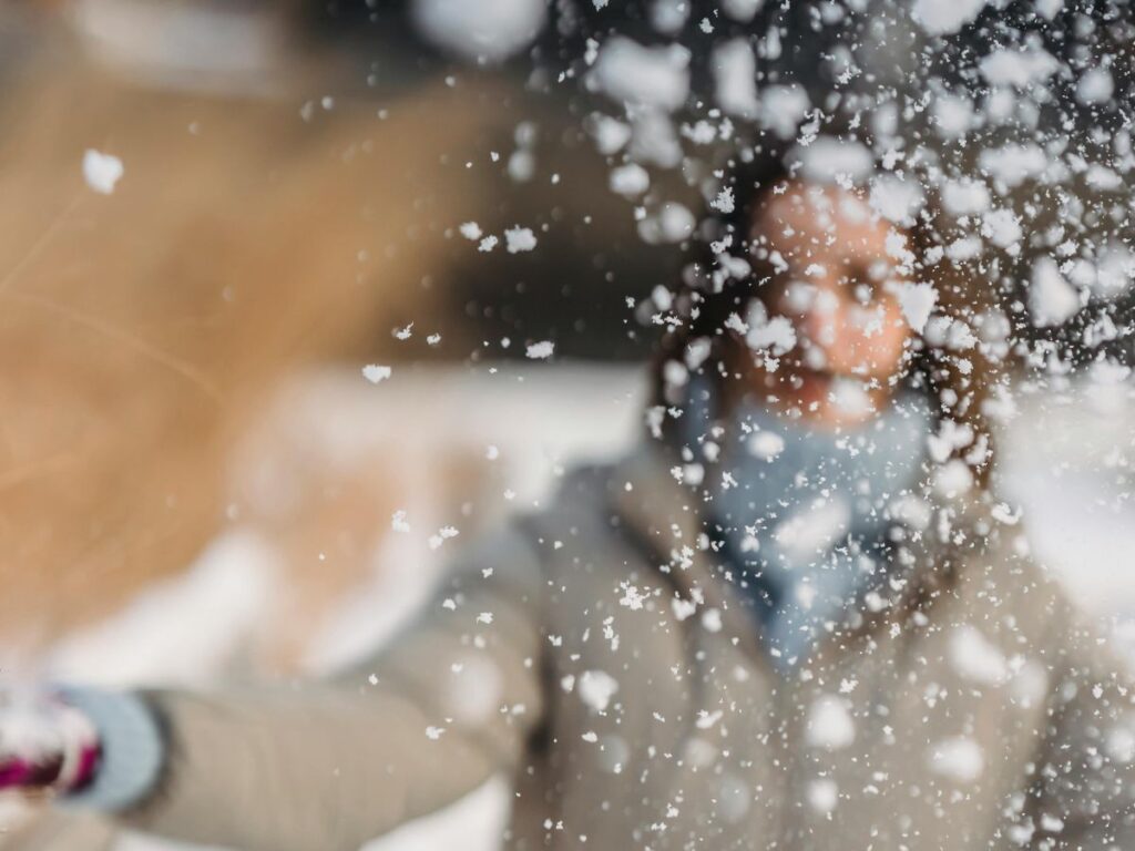 girl playing with snow