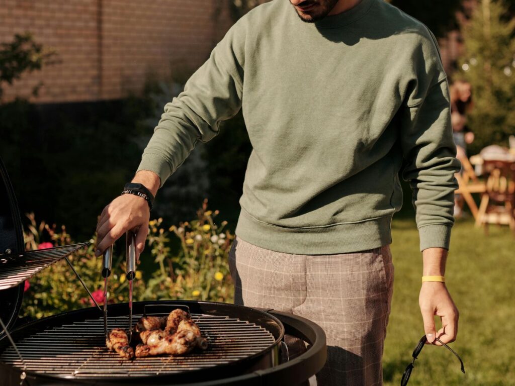 man grilling chicken