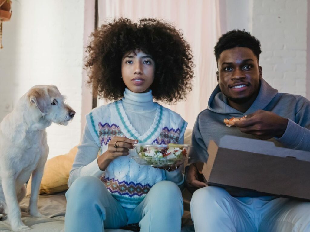 couple watching something and eating