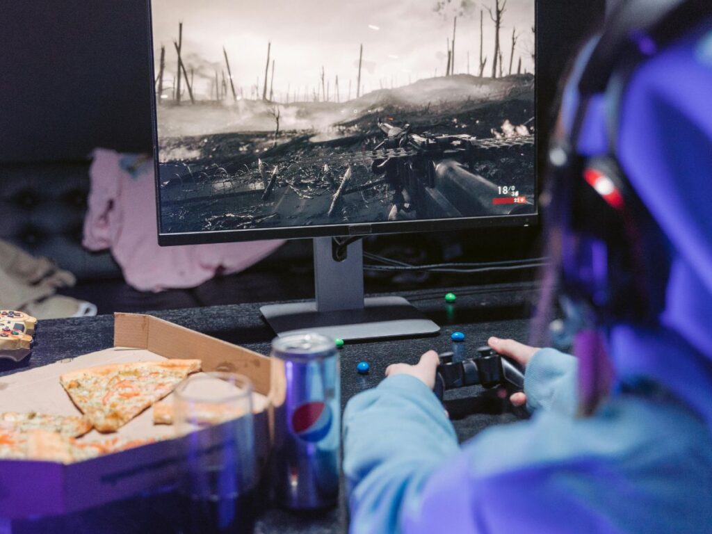 playing video game and eating pizza