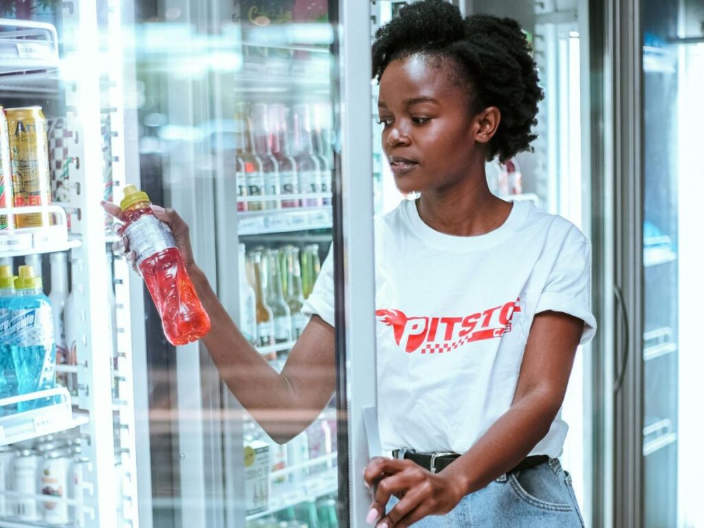 woman buying gatorade in a grocery store