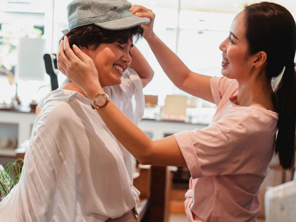 woman trying on a hat