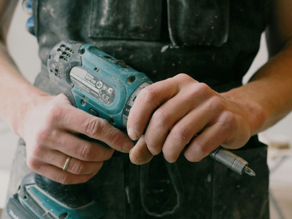 man holding a drill machine