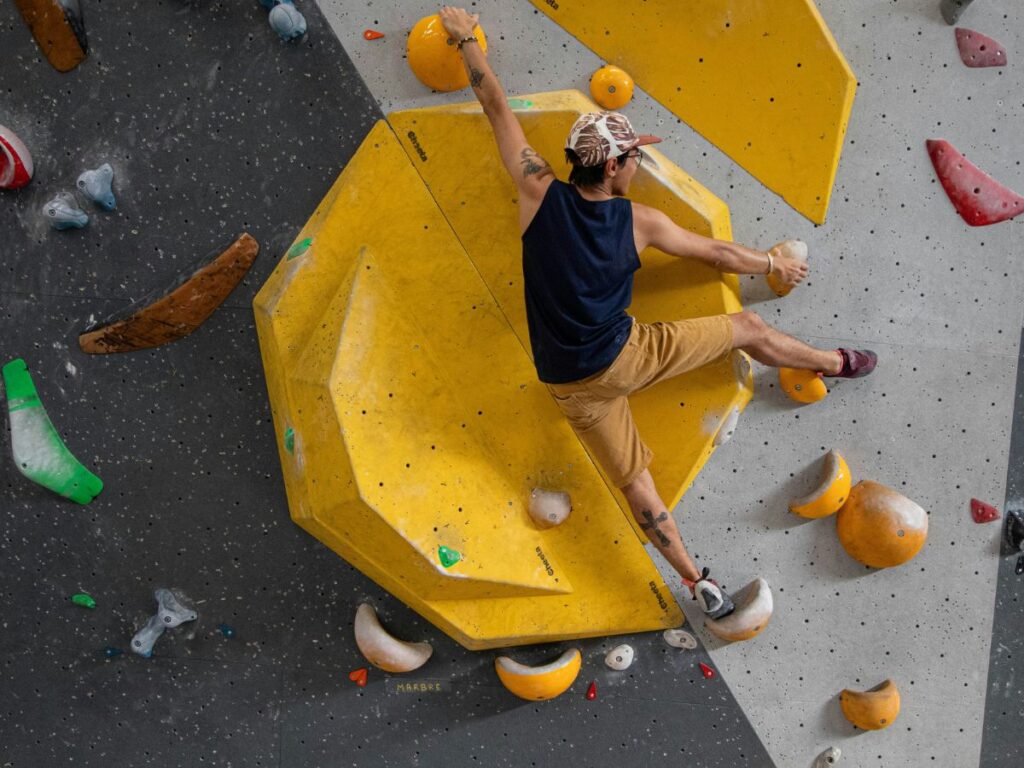 man doing indoor rock climbing