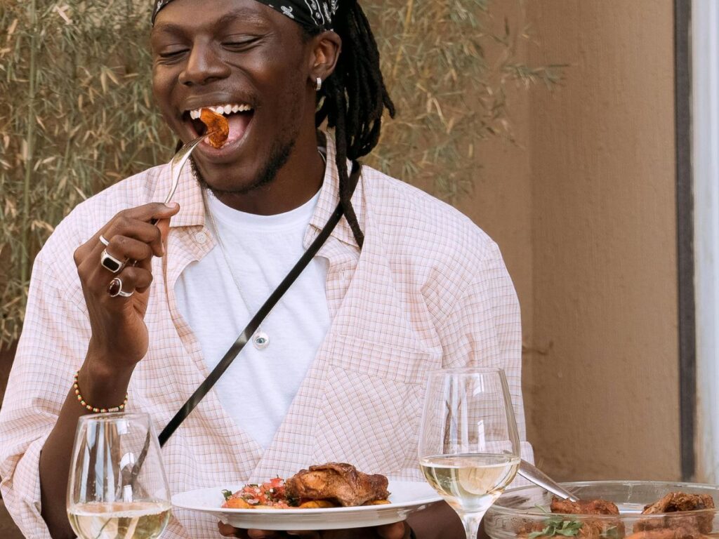 man eating jerk chicken 